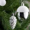 Close-up of Christmas tree ornaments shaped like acorns and pinecones, hanging from a Christmas tree. Produktbild-Vorschau