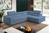 A modern living room with a blue sectional sofa, coffee table, and artwork. Produktbild-Vorschau