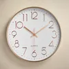 A close-up shot of a wall clock against a textured background. Produktbild-Vorschau