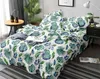 A bed with green leaf patterned bedding in a bedroom setting. Anteprima dell’immagine prodotto