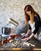A woman making gnocchi in a kitchen with a stand mixer. Náhled obrázku produktu