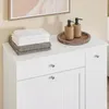 A white storage cabinet with two drawers and a cabinet door, decorated with towels and soap dispensers on top. Náhľad obrázku produktu