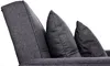 A close-up view of a dark gray sofa with three pillows. Produktbild-Vorschau