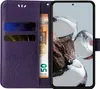 A purple flip phone case with card slots and a euro banknote is shown open, with a smartphone inside displaying a wallpaper. Produktbild-Vorschau