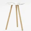 A white marble-patterned table with three wooden legs against a white background. Produktbild-Vorschau