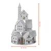 A white, multi-tiered decorative house structure with a tower, resembling a village or a Christmas scene, is displayed against a white background. Dimensions are indicated with measurement lines. Produktbild-Vorschau