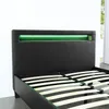 A close-up view of the headboard of a black bed frame with integrated green LED lighting. Produktbild-Vorschau