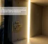 Close-up of a cabinet interior with LED lighting and a hinge. Produktbild-Vorschau