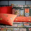 A close-up view of Christmas-themed bedding, including pillows and a duvet cover, arranged on a bed. Anteprima dell’immagine prodotto