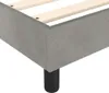 A close-up corner view of a grey upholstered bed frame with wooden slats and a black leg. Náhľad obrázku produktu