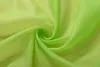 A close-up swirl of lime green sheer fabric. Produktbild-Vorschau