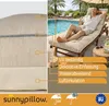 A man relaxing on a sun lounger by a swimming pool, with a cushion on the lounger. Produktbild-Vorschau