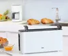 A white BRAUN long-slot toaster with two croissants on a warming rack, placed on a kitchen counter. Náhled obrázku produktu