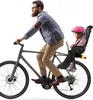 A man is riding a bicycle with a child in a child seat on the back. Náhled obrázku produktu