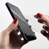 A person's hands are applying a screen protector to a smartphone. Produktbild-Vorschau