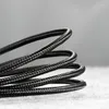 A close-up shot of a coiled black braided cable. Náhled obrázku produktu
