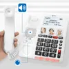 A person's hand holding a telephone handset next to a corded telephone base with a screen and keypad. Náhled obrázku produktu