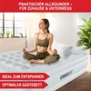A woman meditates on an inflatable mattress in a bright room. Produktbild-Vorschau