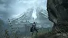 A lone knight stands on a rocky outcrop, gazing at a vast, snow-capped mountain range with a city nestled in the valley below. Produktbild-Vorschau