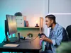A young man is playing a video game on his computer. Náhled obrázku produktu