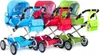 Three doll strollers in different colors (blue, red, and green) are lined up against a white background. Náhľad obrázku produktu