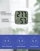 A digital thermometer and hygrometer displaying indoor temperature and humidity, with accompanying graphics illustrating comfort levels. Produktbild-Vorschau
