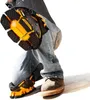 A person is kneeling on the ground wearing work jeans and protective knee pads. Produktbild-Vorschau