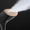 Close-up of a garment steamer emitting steam against a dark background. Podgląd zdjęcia produktu