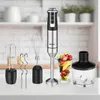 A hand blender and its accessories are displayed on a white countertop in front of a blurred kitchen background. Anteprima dell’immagine prodotto