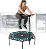 A woman is jumping on a trampoline while watching a fitness video on a laptop and a smartphone. Voir les images du produit