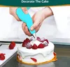 A person is decorating a cake with a piping bag. Produktbild-Vorschau