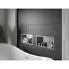 A modern bathroom with a bathtub and built-in shelves in the wall. Náhled obrázku produktu