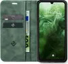 A green flip case for a smartphone, open to reveal card slots and a banknote, with the smartphone screen visible. Produktbild-Vorschau