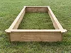 A wooden raised garden bed frame sits on a grassy lawn. Produktbild-Vorschau