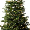A close-up view of a decorated Christmas tree with lights. Produktbild-Vorschau