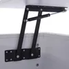 A close-up view of a gas lift mechanism attached to a white furniture item, likely a lift-top coffee table or storage box. Produktbild-Vorschau
