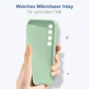 A hand holding a light green phone case against a light blue and white background with German text. Produktbild-Vorschau