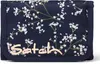 A close-up, front-facing view of a navy blue wallet with a floral pattern and the brand name 'Satch' visible. Náhled obrázku produktu