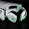 A white gaming headset and controller are placed on a black surface, with a white console in the background. Produktbild-Vorschau
