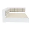 A white daybed with a tufted beige headboard and slatted mattress support, shown from a side angle against a white background. Náhled obrázku produktu