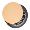 A round cardboard protector is placed over a car wheel and tire. Produktbild-Vorschau