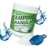 A product container of camping granulate with a scoop and water splashes. Produktbild-Vorschau