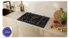 A modern kitchen countertop with a gas hob, sink, and decorative items. Anteprima dell’immagine prodotto