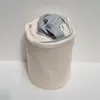 A rolled-up mattress topper or protector with gray straps on a white and gray textured background. Produktbild-Vorschau