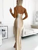 A woman wearing a beige dress in a room. Produktbild-Vorschau