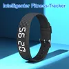 A black fitness tracker with a digital display is shown against a blue background. Produktbild-Vorschau