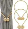 A product image showing two magnetic curtain clips, one attached to a grey curtain and another shown separately. Náhled obrázku produktu