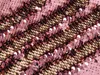 A close-up view of pink and gold sequins on fabric. Produktbild-Vorschau
