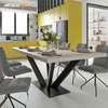 A modern dining room with a yellow kitchen and a dining table set for a meal. Voir les images du produit