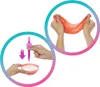 Two circular panels showing hands interacting with a product. The left panel shows a hand holding a pink tool over a bowl of white substance, with a downward arrow indicating action. The right panel shows hands stretching an orange, slime-like material. Podgląd zdjęcia produktu